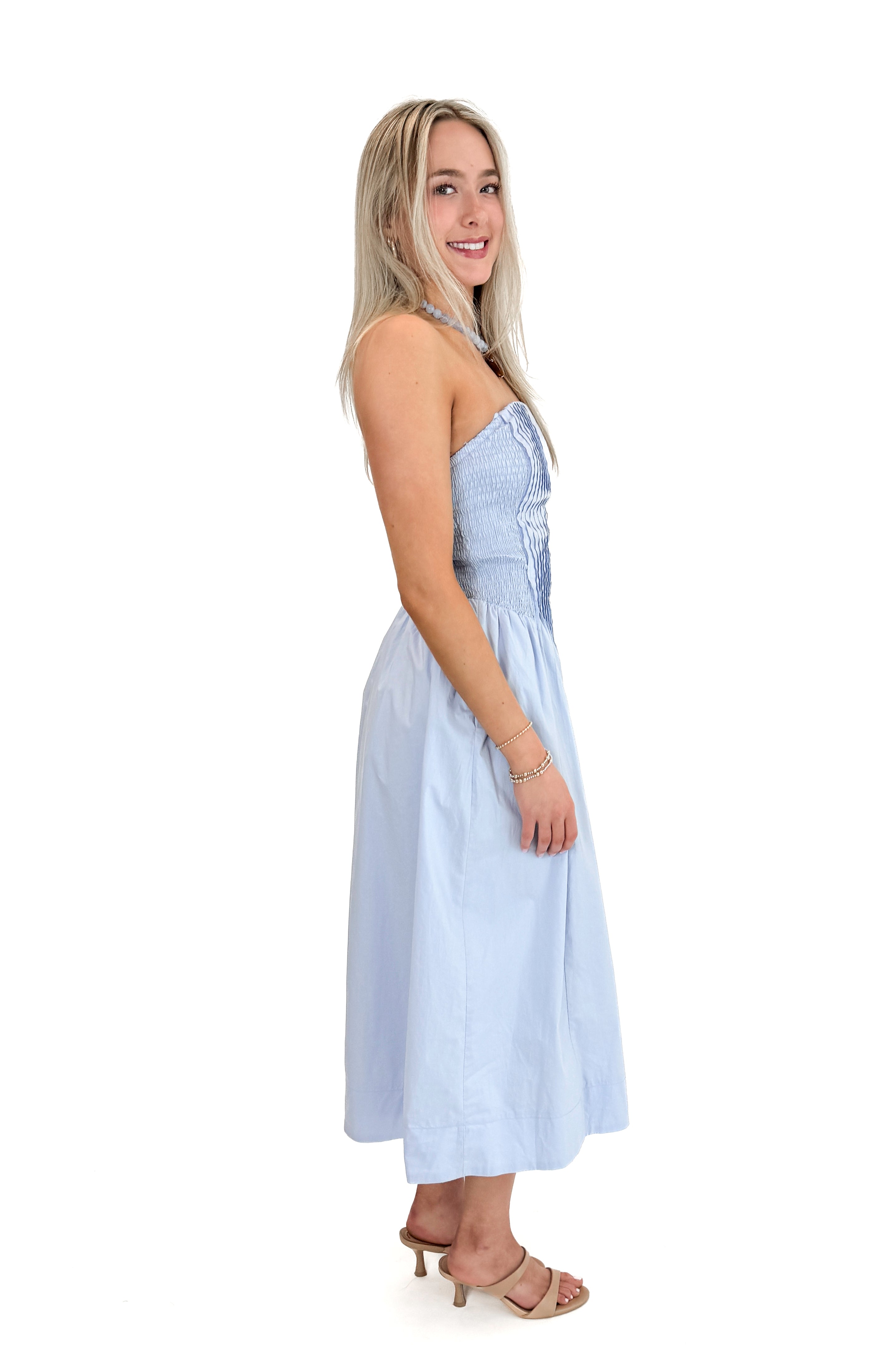 Side view of woman wearing Light Blue Pintucked Detail Midi Dress against white studio background.