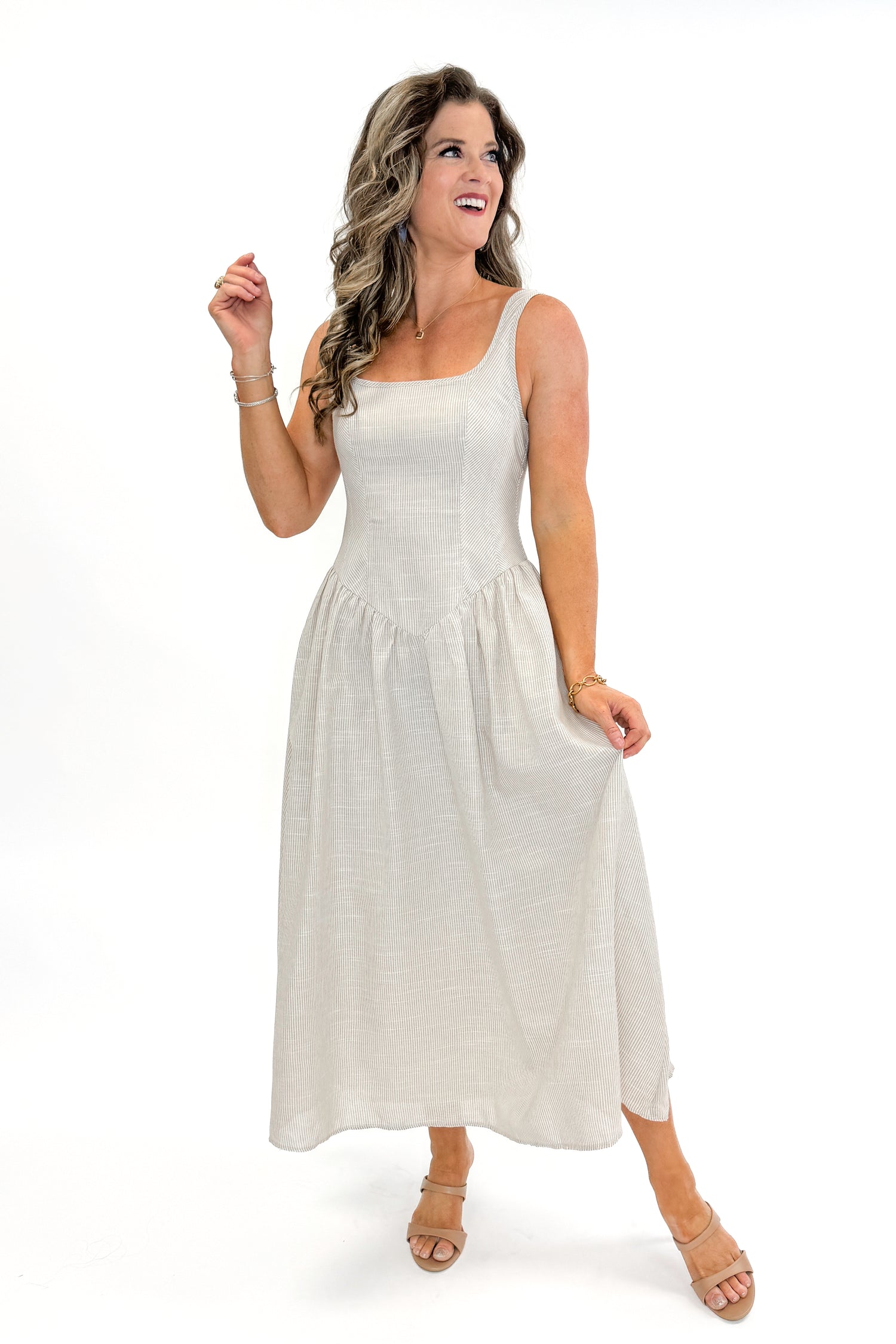 Front view of woman wearing Taupe Striped V-Waist Dress against white studio background.