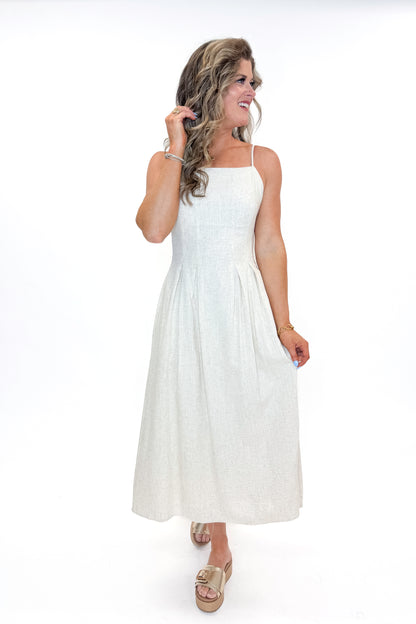 Front view of woman wearing Linen Pleat Detail Tank Dress with sandals against white studio background.