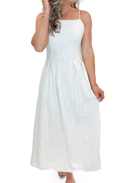 Front detail view of woman wearing Linen Pleat Detail Tank Dress with sandals against white studio background.