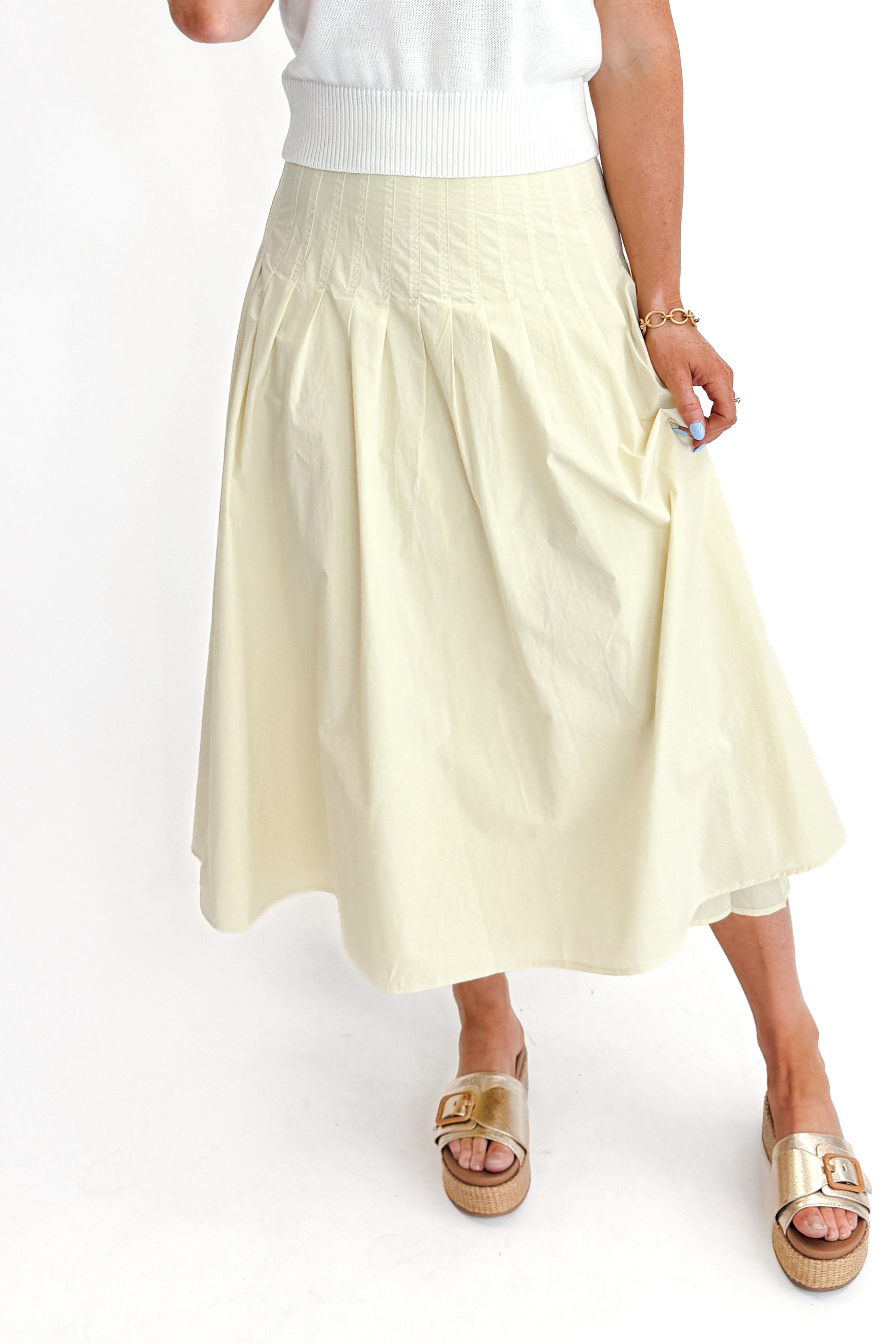 Front view of woman wearing top with Yellow Pleat Detail Midi Skirt against white studio background.