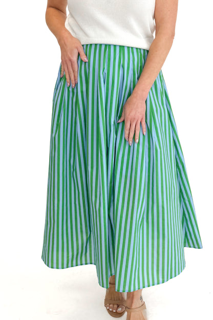 Front view of woman wearing Green &amp; Blue Striped Skirt by Entro with white sweater against white studio background.