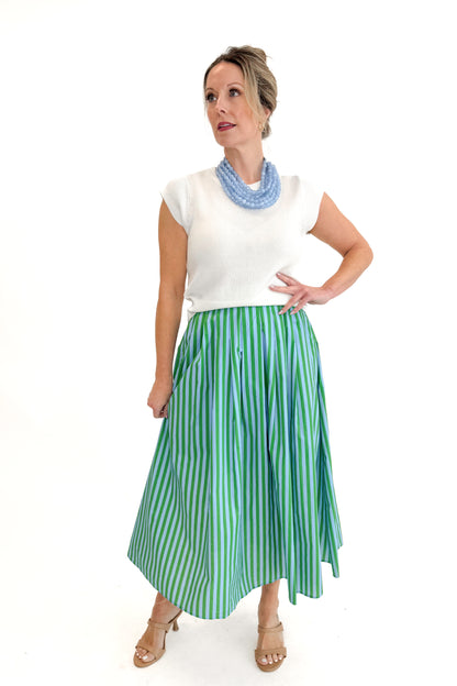 Front view of woman wearing Green &amp; Blue Striped Skirt by Entro with white sweater against white studio background.