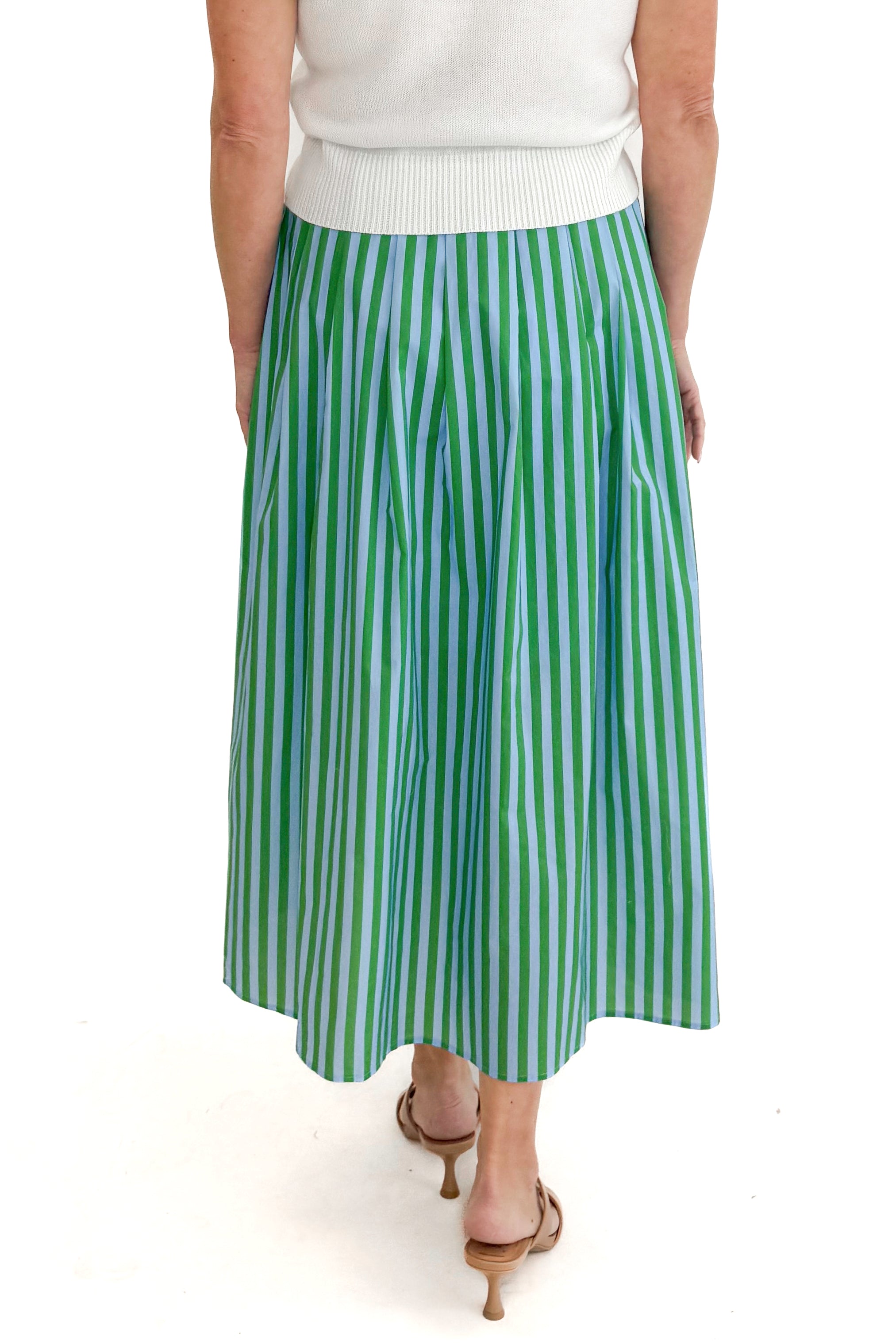 Back view of woman wearing Green &amp; Blue Striped Skirt by Entro with white sweater against white studio background.