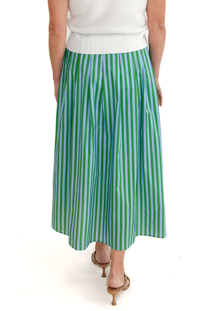 Back view of woman wearing Green &amp; Blue Striped Skirt by Entro with white sweater against white studio background.
