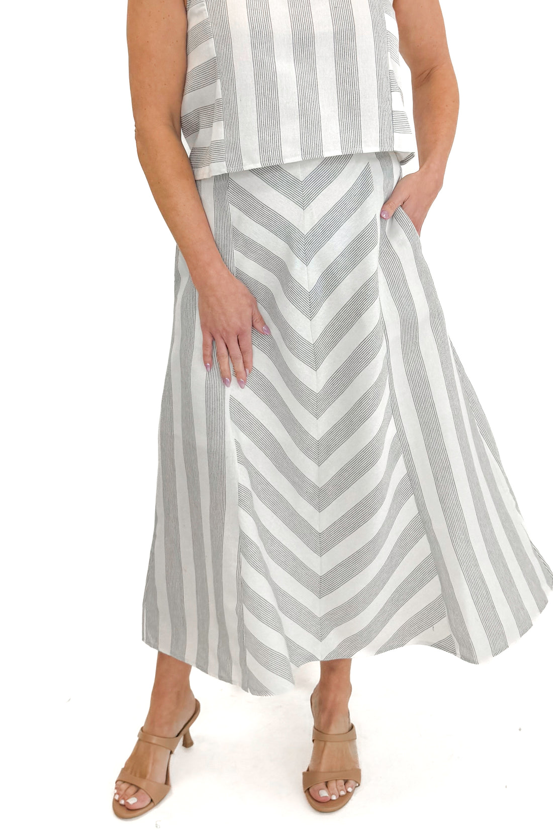 Front view of woman wearing Cream &amp; Grey Striped Skirt by Entro with matching tank against white studio background.