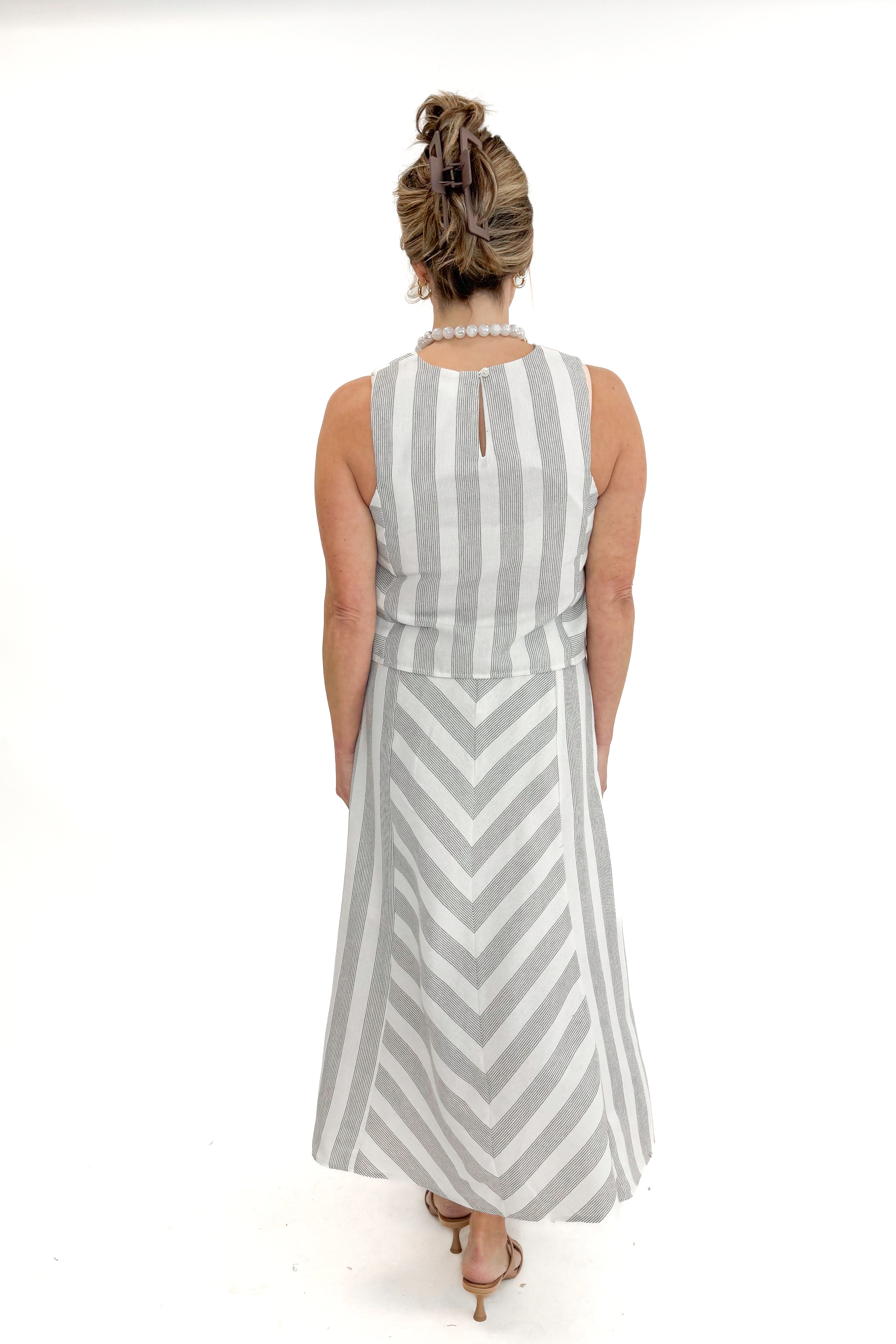 Back view of woman wearing Cream &amp; Grey Striped Skirt by Entro with matching tank against white studio background.