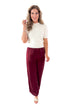 Front view of woman wearing cream sweater and Wine Satin Wide Leg Pants against white studio background.