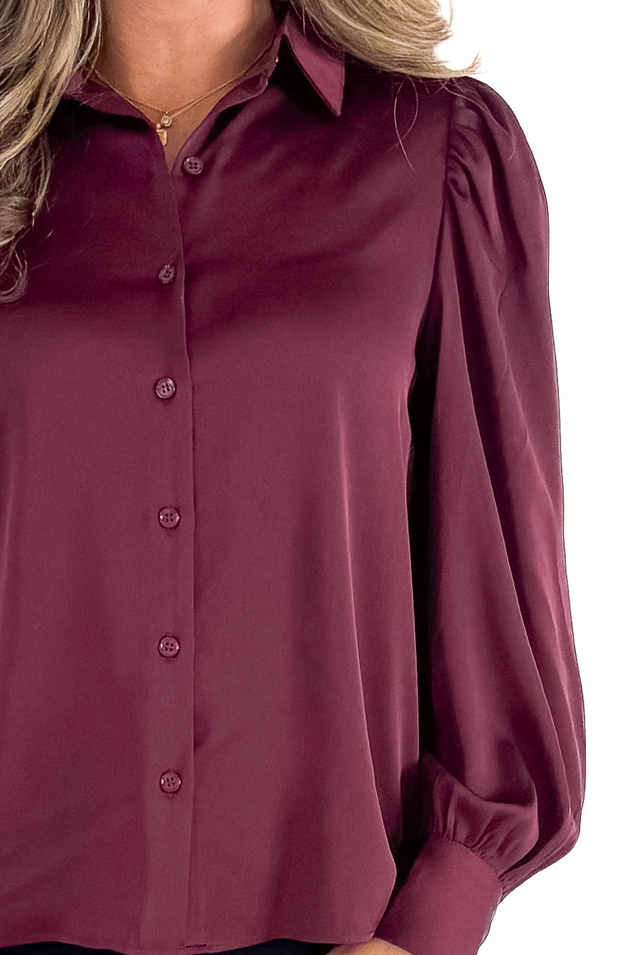 Front detailed view of woman wearing Plum Satin Button Up Top with jeans against white studio background.