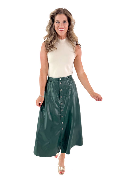 Front view of woman wearing Cream Fitted Mock Neck Sleeveless Top with skirt against white studio background.