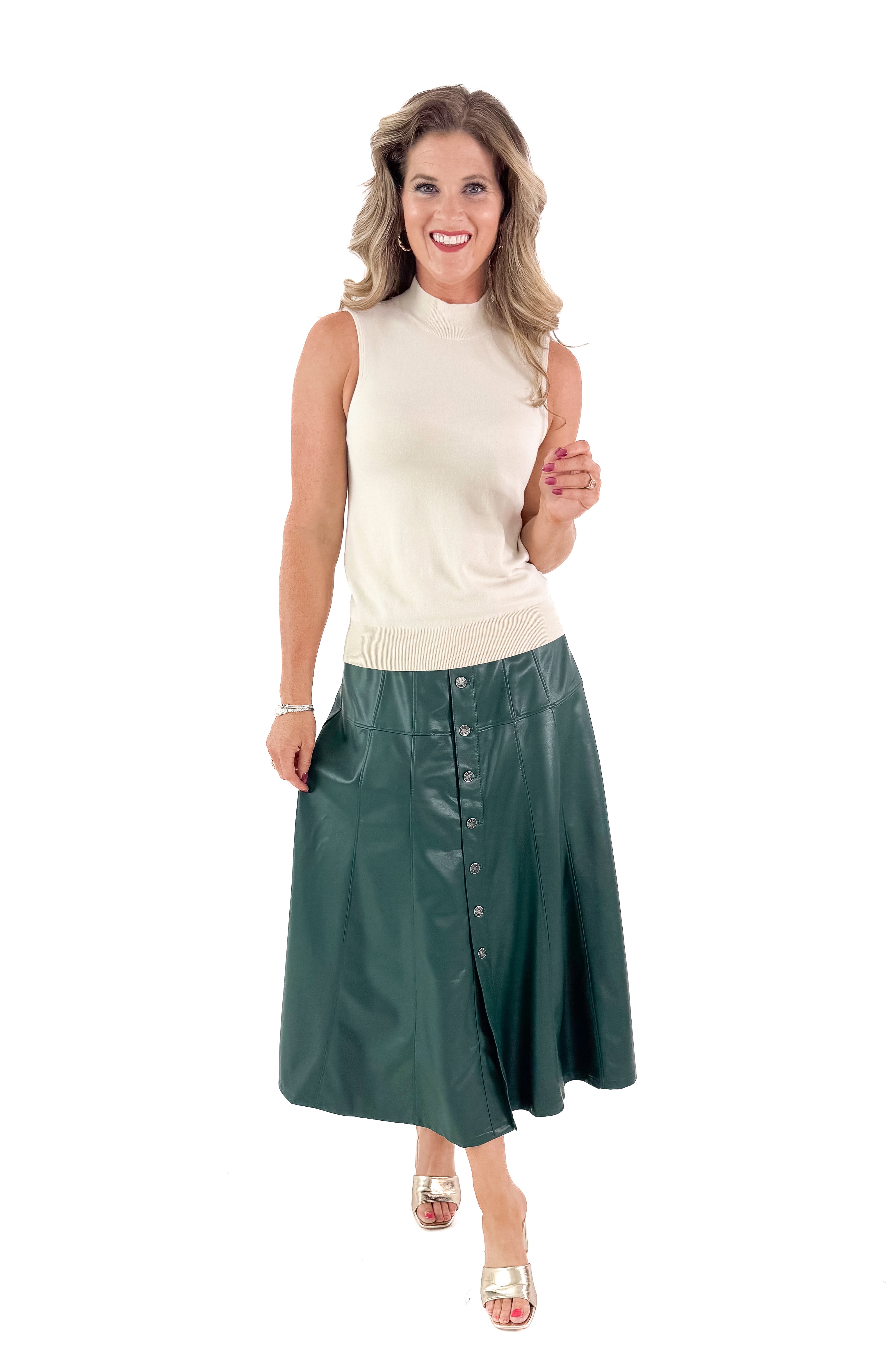 Front view of woman wearing Cream Fitted Mock Neck Sleeveless Top with skirt against white studio background.