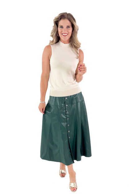 Front view of woman wearing Cream Fitted Mock Neck Sleeveless Top with skirt against white studio background.