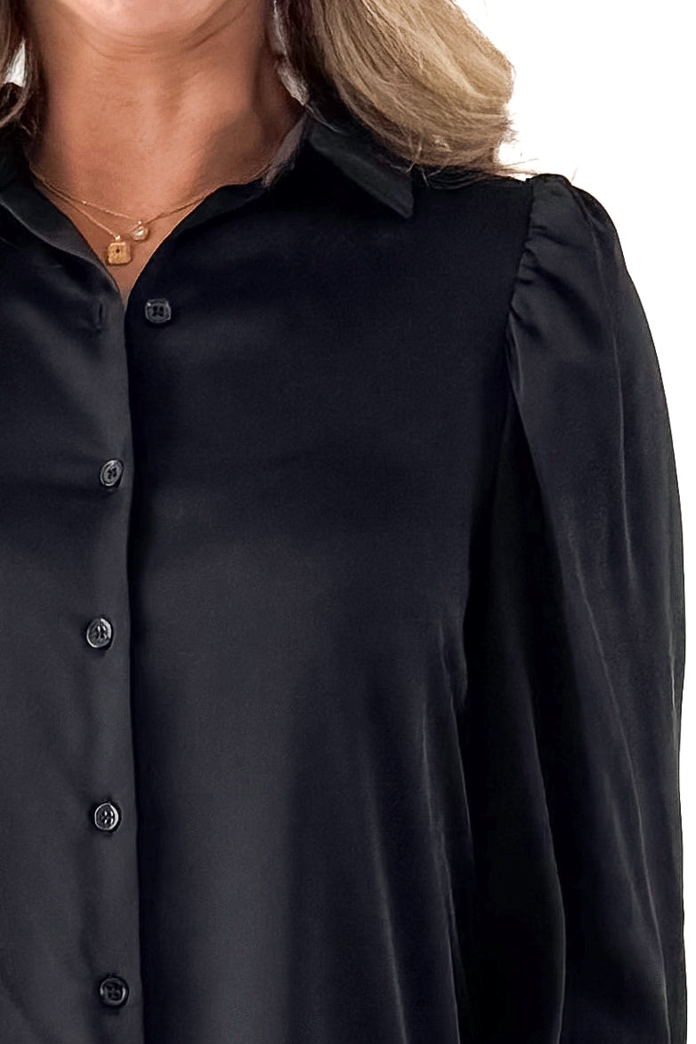 Front detailed view of woman wearing Black Satin Button Up Top with jeans against white studio background.