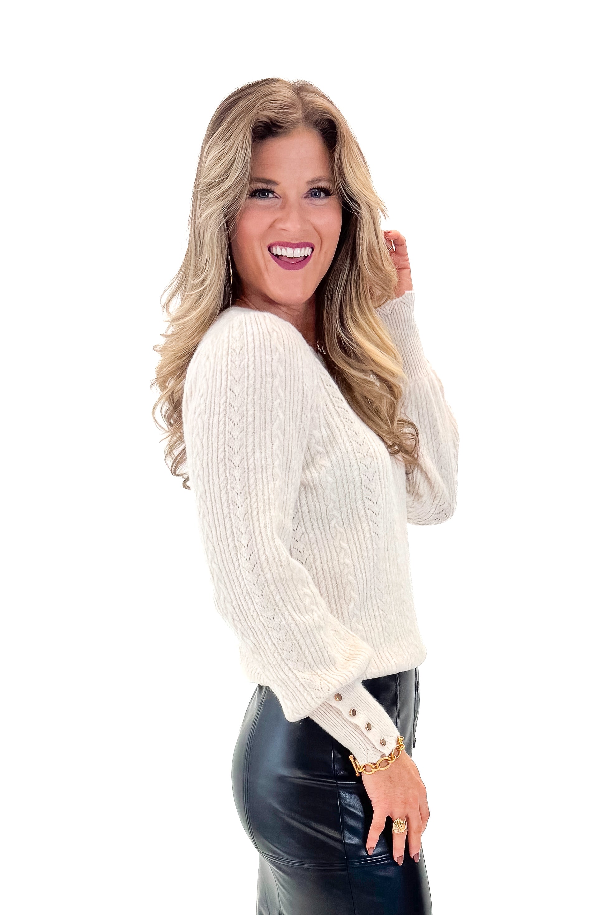 Side view of woman wearing Cream Textured Scallop Detail Sweater with skirt against white studio background.