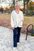 Front view of woman wearing Cream Pocket & Stitch Detail Sweater with jeans outside.