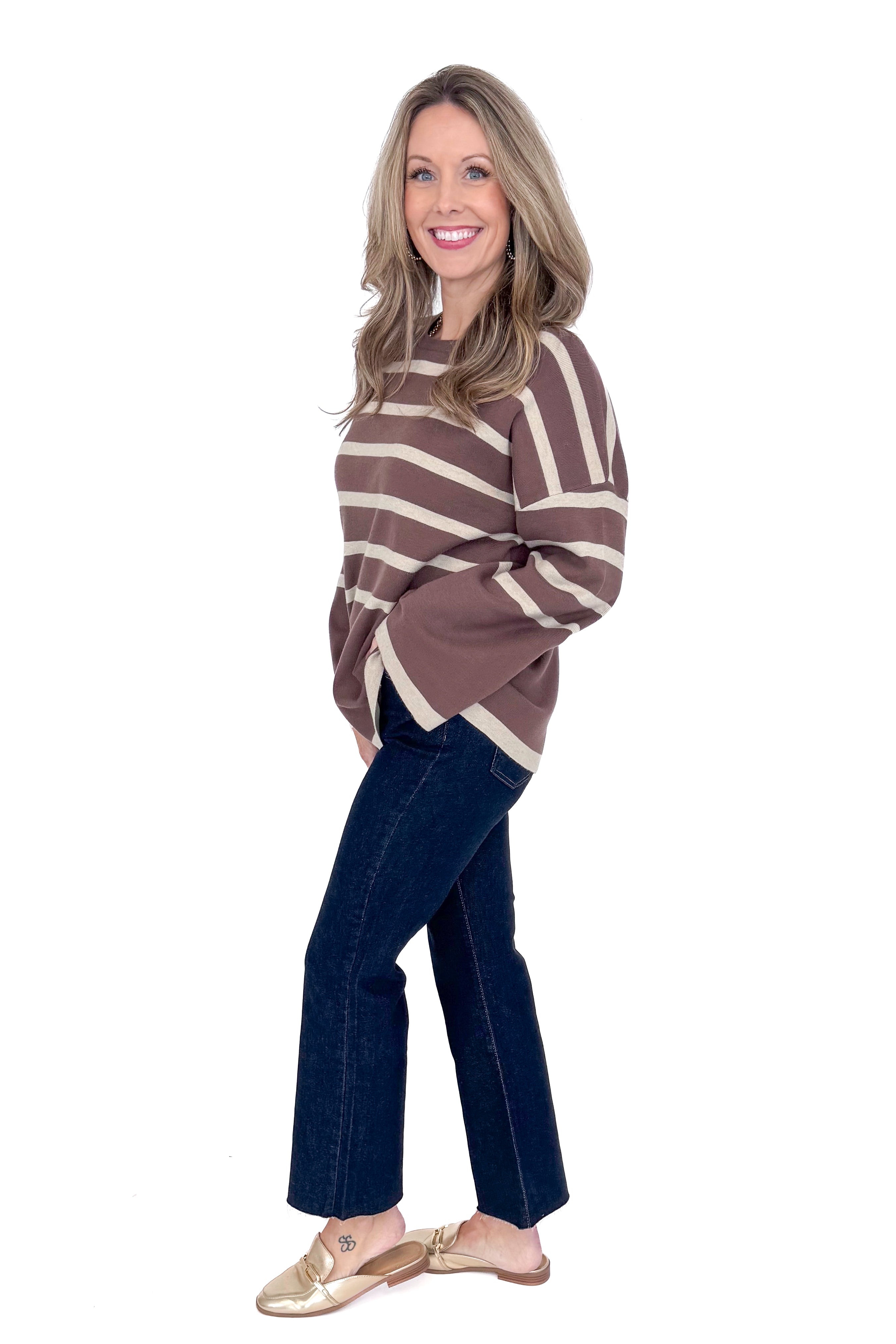 Side picture of woman wearing Mocha &amp; Brown Striped Sweater by She + Sky with white background.