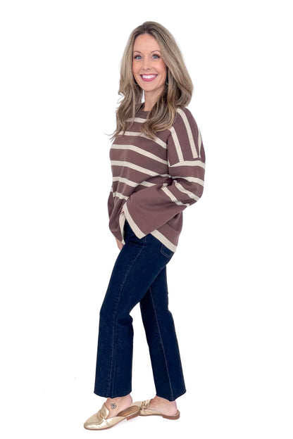 Side picture of woman wearing Mocha &amp; Brown Striped Sweater by She + Sky with white background.