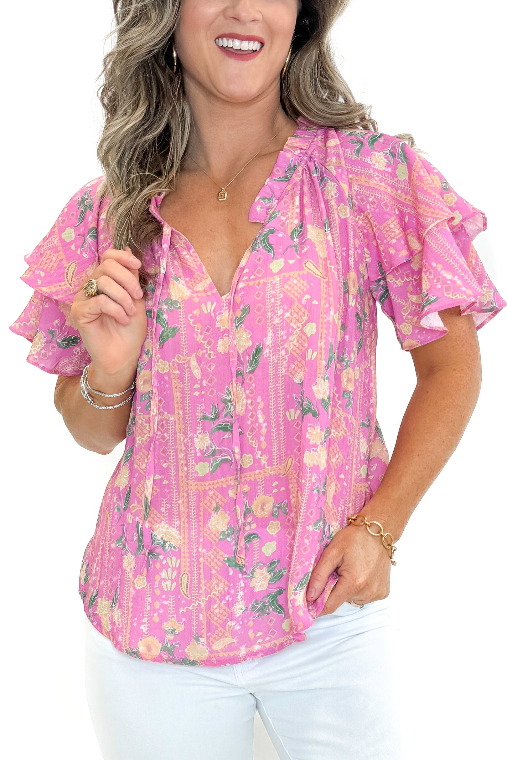 Front view of woman wearing Pink Floral Printed Ruffle Sleeve Top with jeans against white studio background.