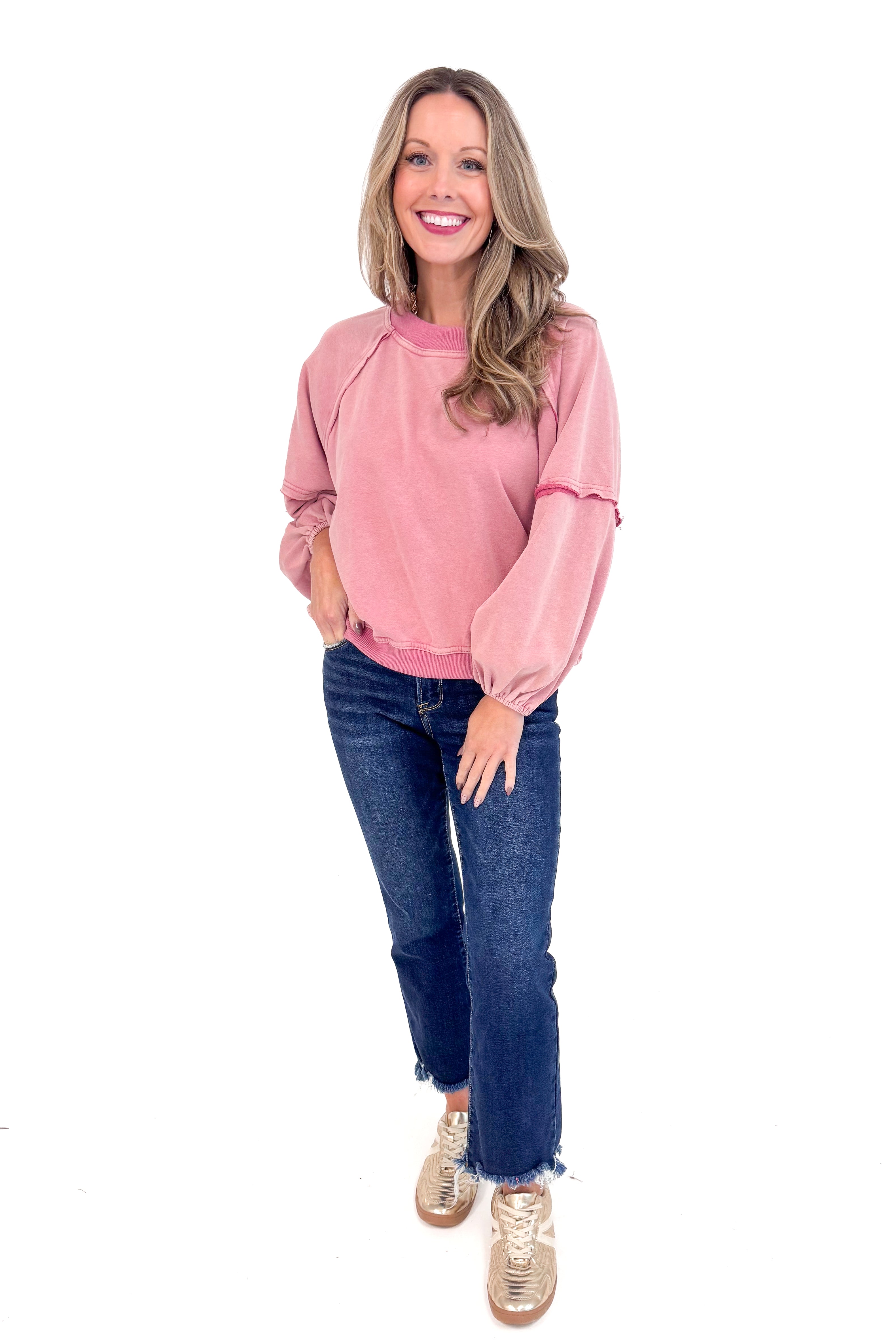 Woman wearing Washed Mauve Puff Sleeve Sweatshirt by She + Sky and jeans.