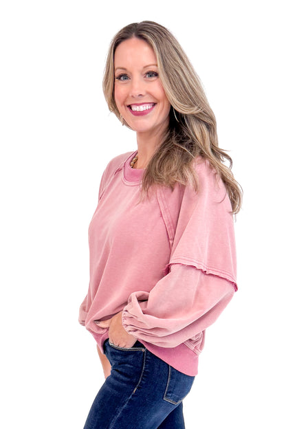 Side view of woman wearing Washed Mauve Puff Sleeve Sweatshirt by She + Sky and jeans.