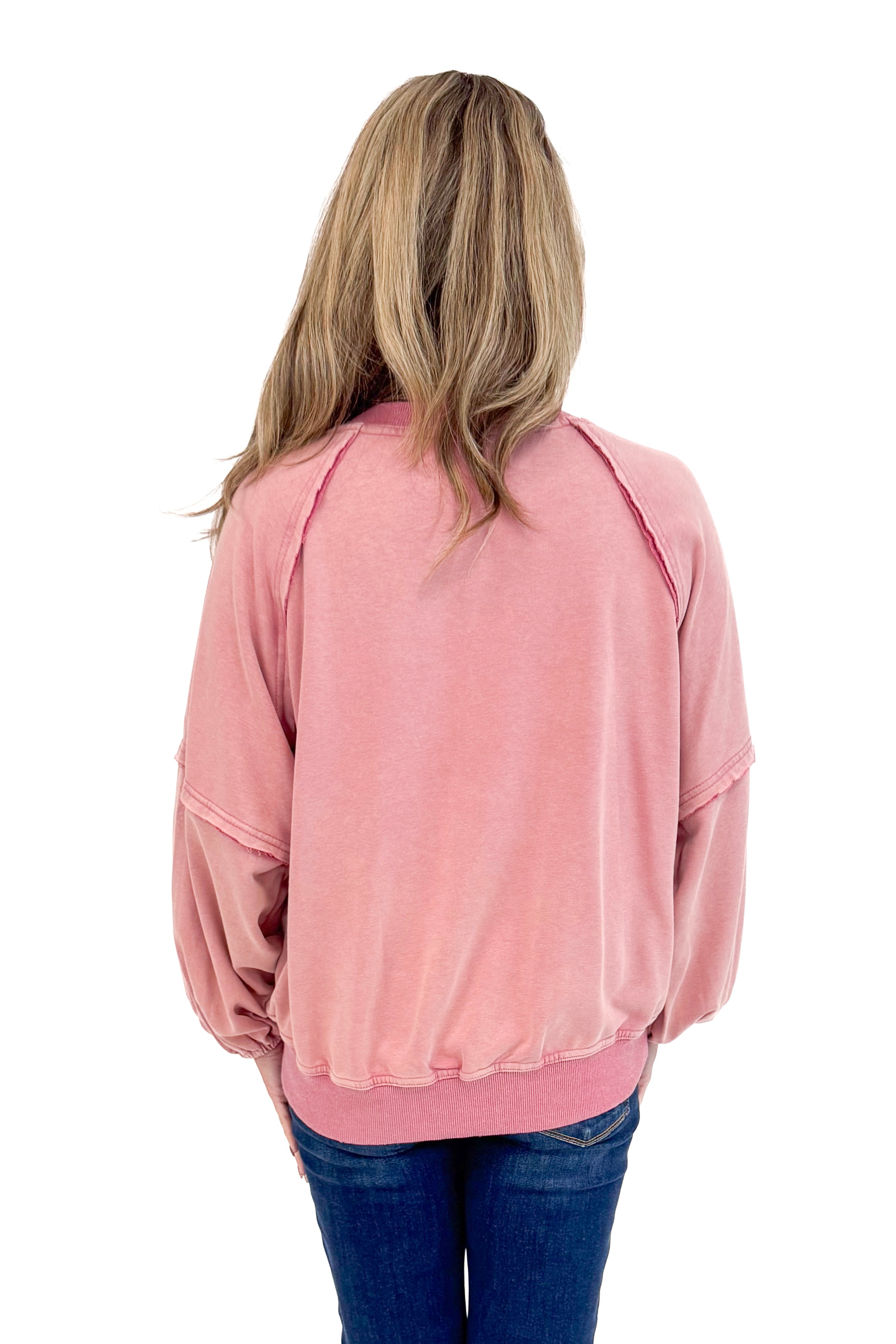 Back view of woman wearing Washed Mauve Puff Sleeve Sweatshirt by She + Sky and jeans.