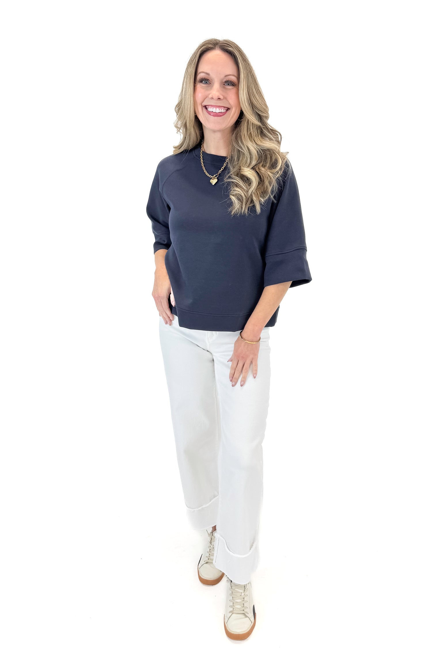 Front view of woman wearing Navy Super Soft Half Sleeve Top with jeans against white studio background.
