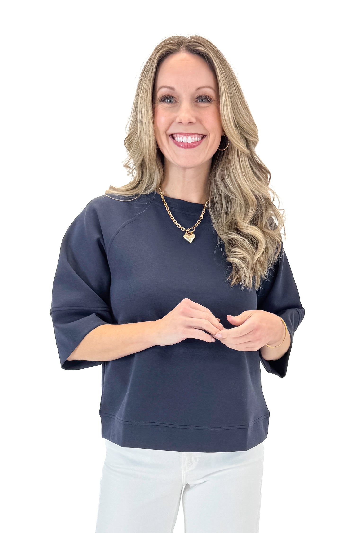 Front view of woman wearing Navy Super Soft Half Sleeve Top with jeans against white studio background.