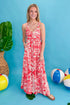 Front view of woman wearing Red Printed Sleeveless V-neck Maxi Dress against blue beachy background.