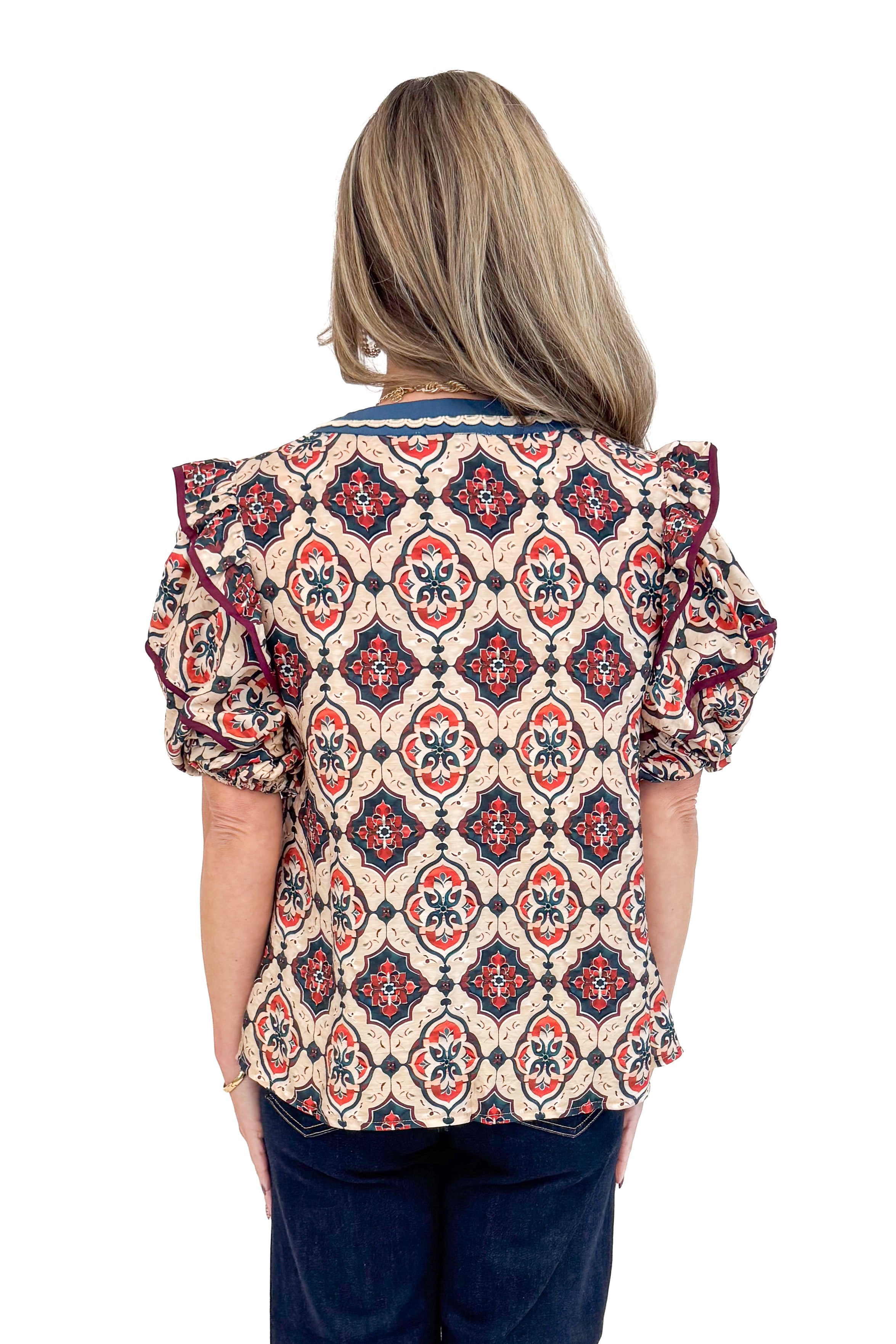 Back view of woman wearing Teal and Wine Printed V-neck Top and jeans with white background.