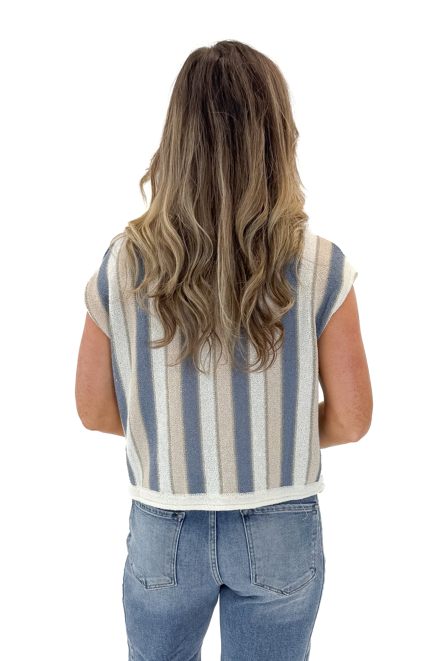 Back view of woman wearing Blue &amp; Tan Striped Short Sleeve Sweater with jeans against white studio background.