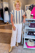 Front view of woman wearing Blue & Tan Striped Short Sleeve Sweater with jeans at a boutique.