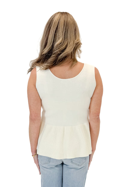 Back view of woman wearing Cream Peplum Sweater Tank with jeans against white studio background.