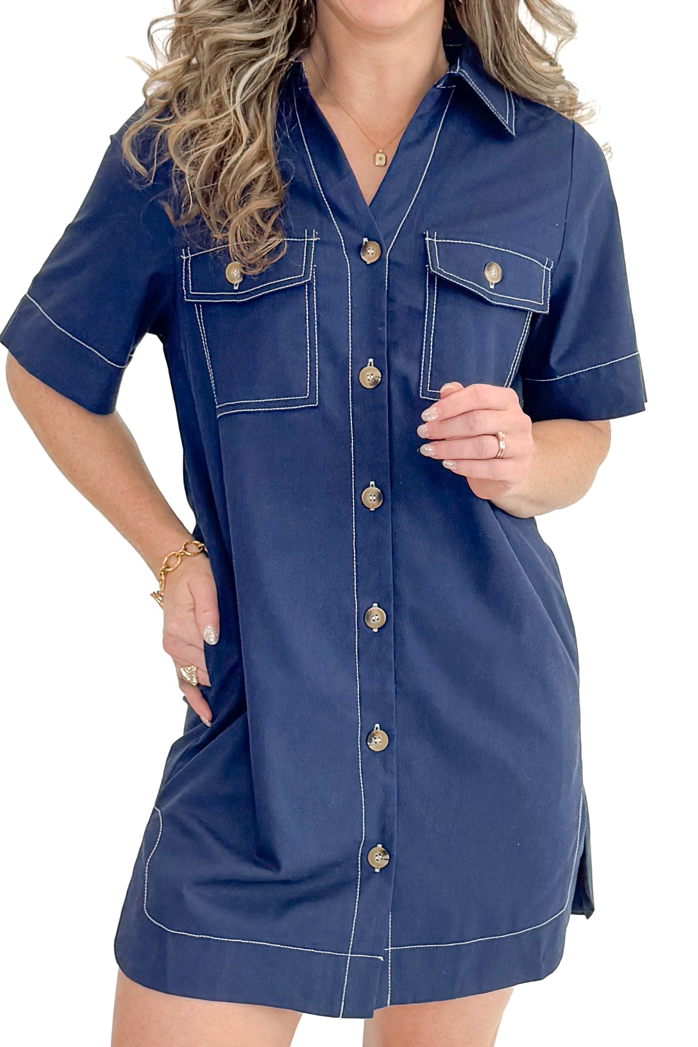 Front detail view of woman wearing Navy Stitch Detail Button Down Dress with sneakers against white studio background.