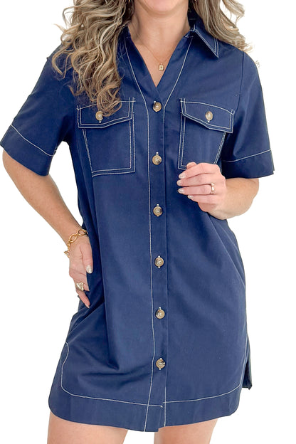 Front detail view of woman wearing Navy Stitch Detail Button Down Dress with sneakers against white studio background.