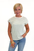 Front view of woman wearing Swagger Boutique’s Sage & Cream Stripe Cap Sleeve Tee with jeans against white studio background.