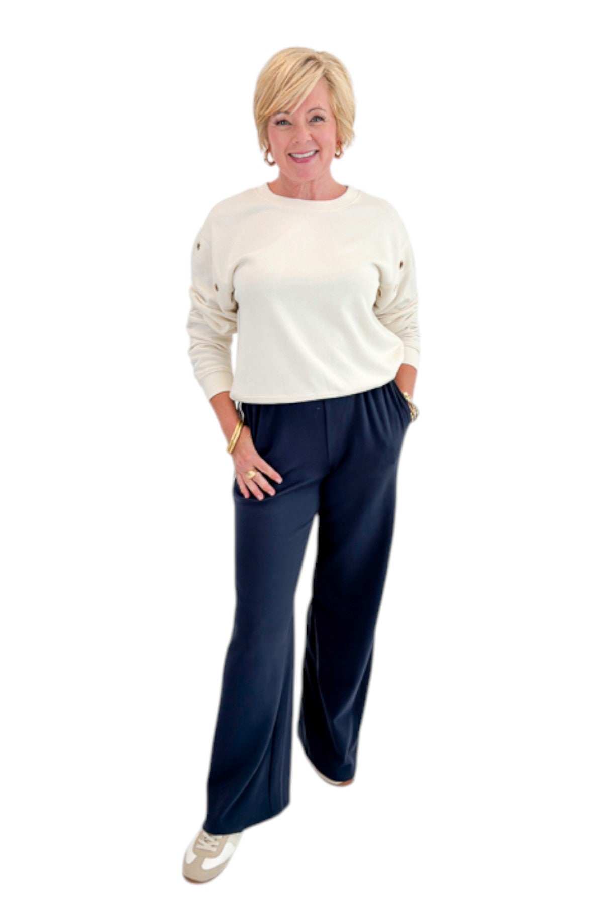 Front view of woman wearing Swagger Boutique’s Sandstone Axel Grommet Sweatshirt by Z Supply with Eclipse Breakaway Track Pants by Z Supply against white studio background.