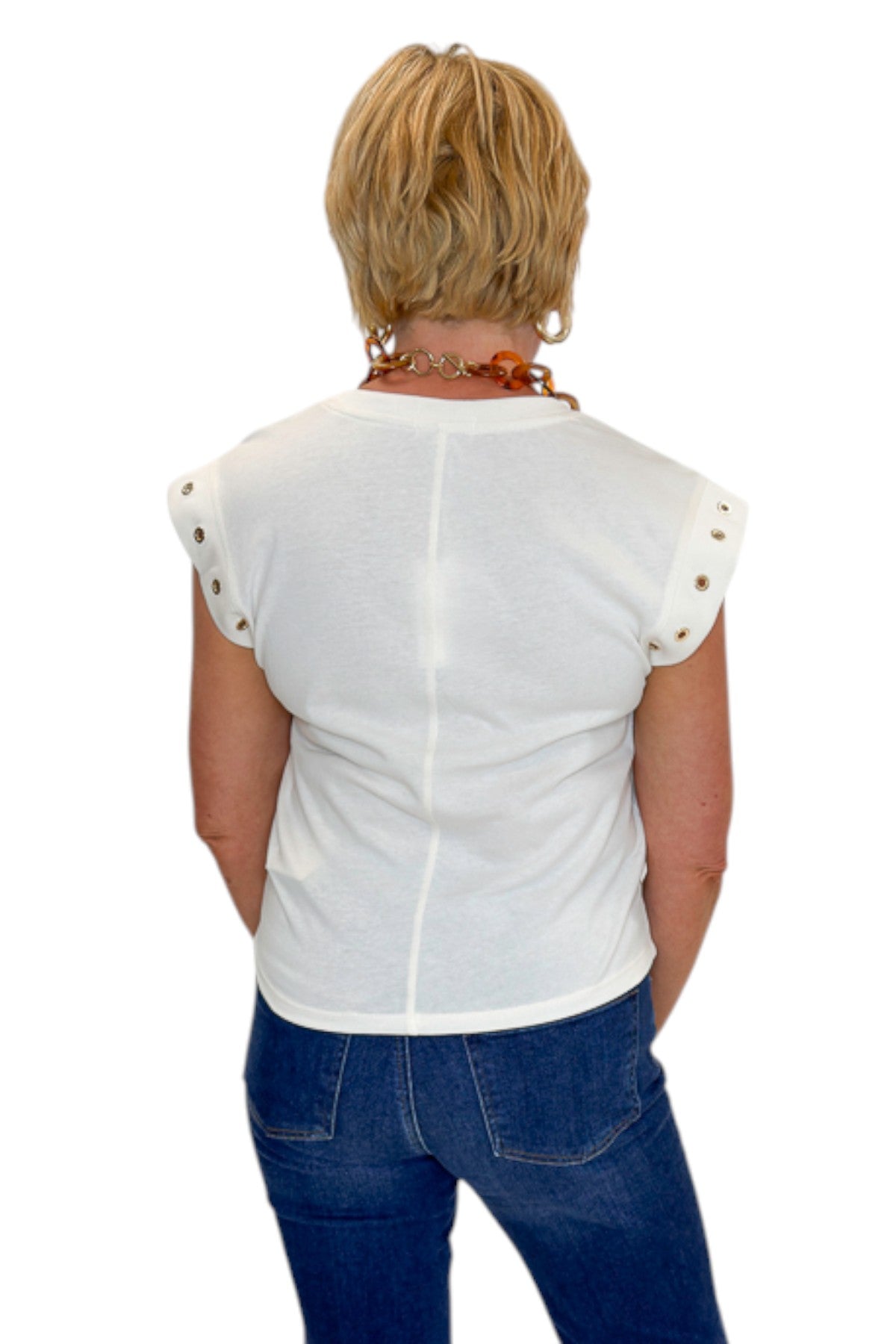 Back view of woman wearing Swagger Boutique’s Sandstone Camino Grommet Top by Z Supply with jeans against white studio background.
