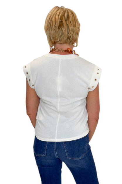 Back view of woman wearing Swagger Boutique’s Sandstone Camino Grommet Top by Z Supply with jeans against white studio background.