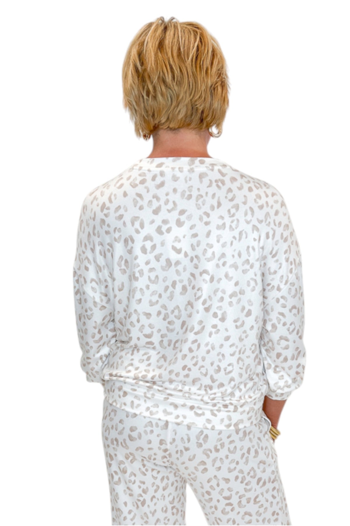 Back view of woman wearing Swagger Boutique’s Sandstone Soft Leo Long Sleeve Top with matching Joggers by Z Supply against white studio background.