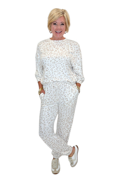 Front view of woman wearing Swagger Boutique’s Sandstone Soft Leo Long Sleeve Top with matching Joggers by Z Supply against white studio background.