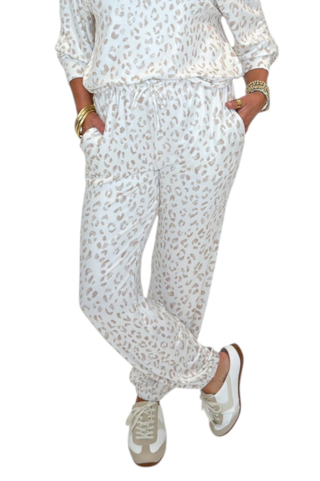 Front detail view of woman wearing Swagger Boutique’s Sandstone Soft Leo Long Sleeve Top with matching Joggers by Z Supply against white studio background.
