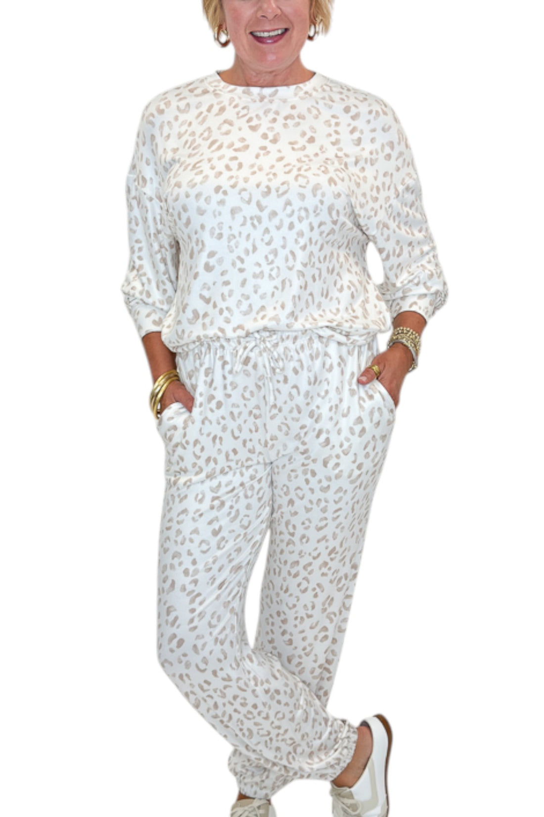 Front detail view of woman wearing Swagger Boutique’s Sandstone Soft Leo Long Sleeve Top with matching Joggers by Z Supply against white studio background.