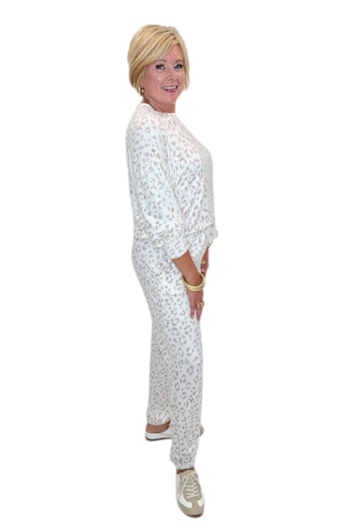 Side view of woman wearing Swagger Boutique’s Sandstone Soft Leo Long Sleeve Top with matching Joggers by Z Supply against white studio background.