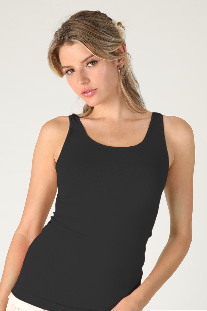A woman modeling a black scoop-neck tank top against a light gray studio background.