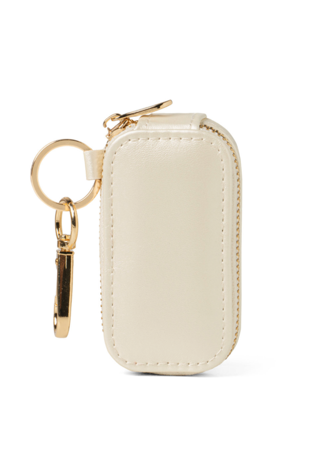 Beige keychain case with gold keyring on a white background