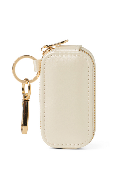 Beige keychain case with gold keyring on a white background