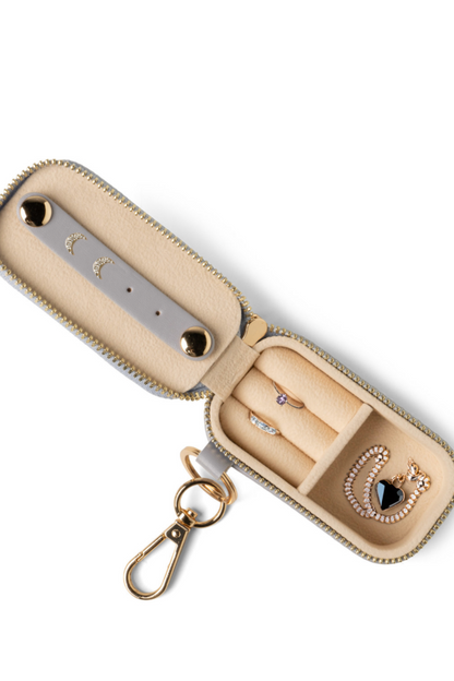 Beige jewelry case with a keychain on a white background