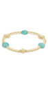 A gold beaded bracelet featuring two oval light blue-green turquoise beads and a gold cross clasp, displayed on a clean white background.