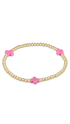 gold enewton bracelet with pink cross detailing  on plain white background