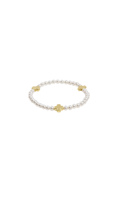 Pearl bracelet with gold accents on a white background